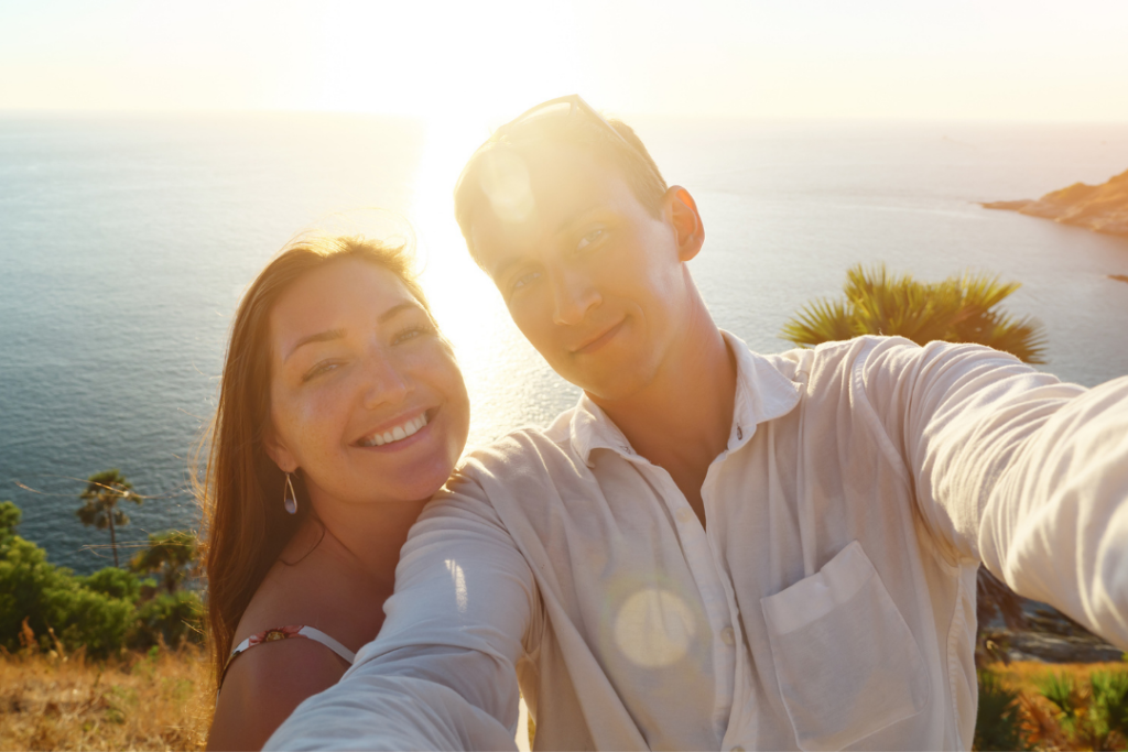 Couple in front of the shore at sunset