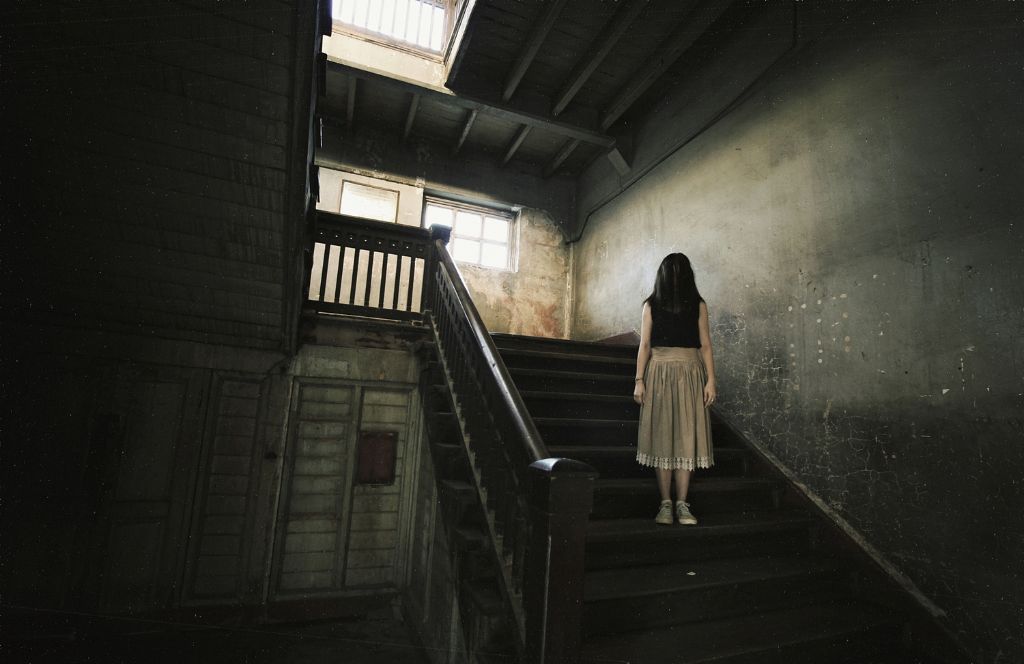 a girl stands on a step at one of the most haunted hotels in the UK