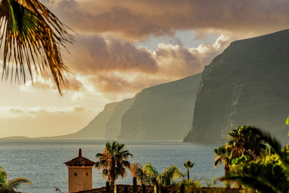 The towering volcanic cliffs of Los Gigantes bathed in golden light, one of the most impressive Tenerife attractions on the west coast.